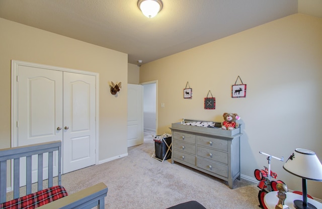 bedroom featuring light carpet, a closet, and vaulted ceiling