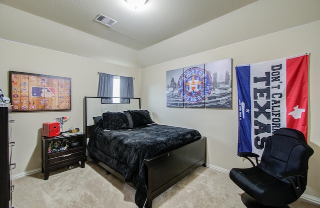 carpeted bedroom with a textured ceiling