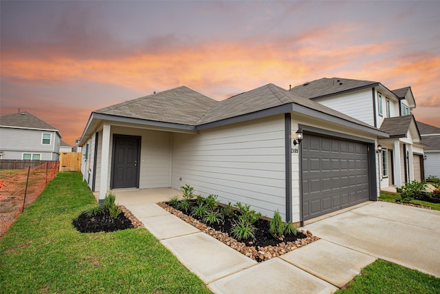 view of front of property with a yard and a garage