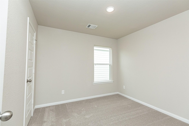 empty room featuring carpet floors and a textured ceiling