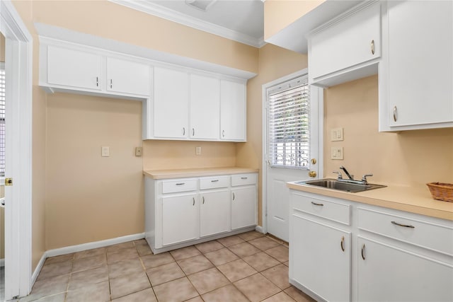 kitchen featuring crown molding, white cabinetry, and sink