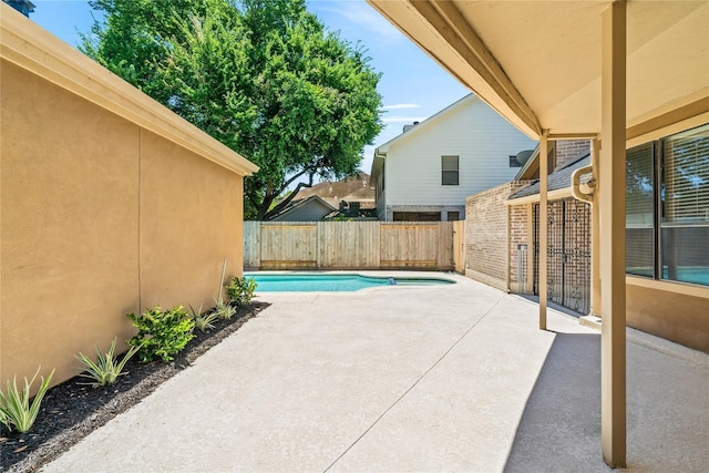 view of patio with a fenced in pool