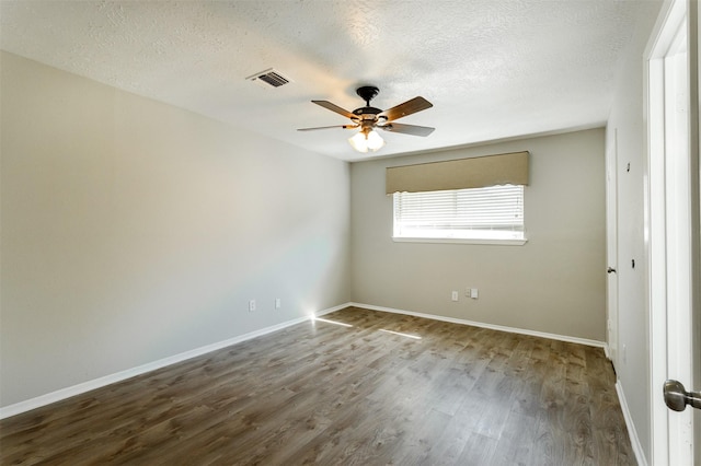 empty room with hardwood / wood-style floors, ceiling fan, and a textured ceiling