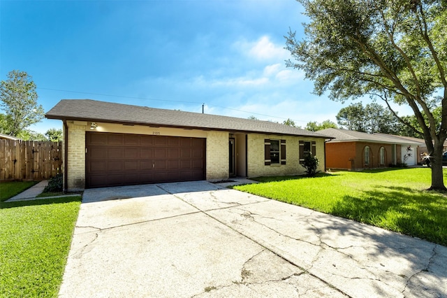 ranch-style home with a garage and a front lawn