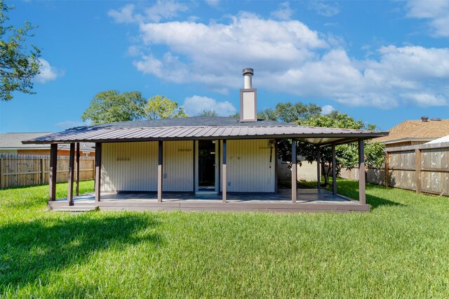 rear view of house featuring a patio and a lawn