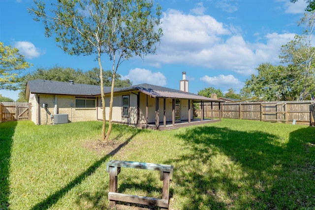 rear view of house featuring a lawn, a patio, and central AC unit