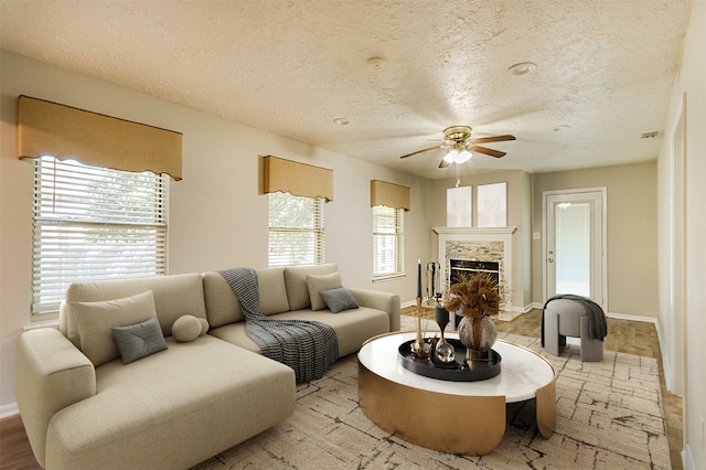 living room with a textured ceiling and ceiling fan