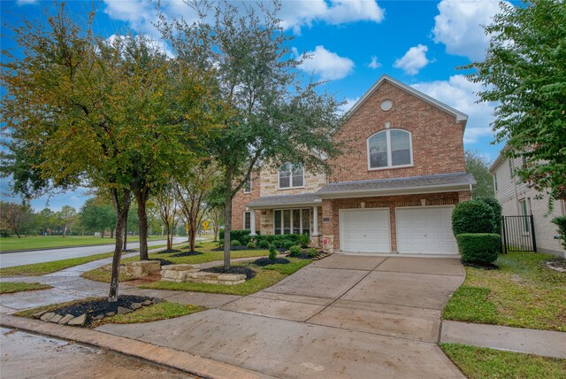 view of front of home with a front lawn and a garage