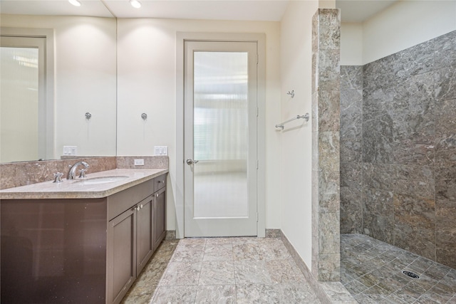 bathroom featuring vanity and a tile shower