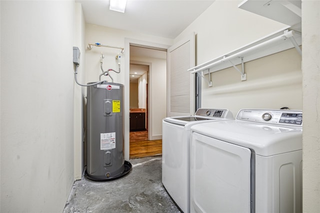 clothes washing area featuring independent washer and dryer and water heater