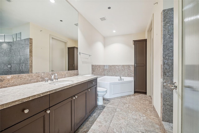 bathroom with vanity, toilet, and a bath