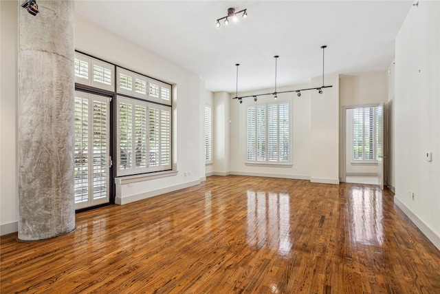 interior space featuring hardwood / wood-style flooring and rail lighting