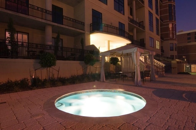 view of pool with a patio and a hot tub