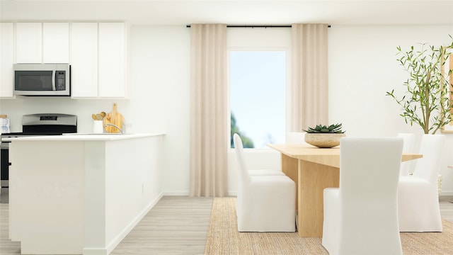 kitchen featuring white cabinetry, light wood-type flooring, and appliances with stainless steel finishes