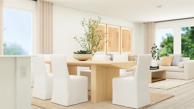 dining space featuring wood-type flooring and a healthy amount of sunlight