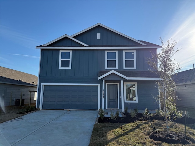 view of front property featuring a garage and central AC unit