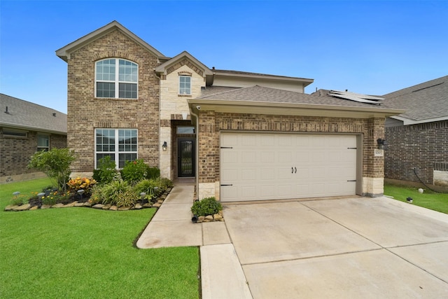 view of front of home featuring a garage and a front yard