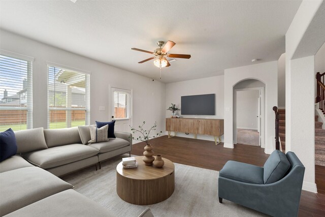 living room featuring wood-type flooring and ceiling fan