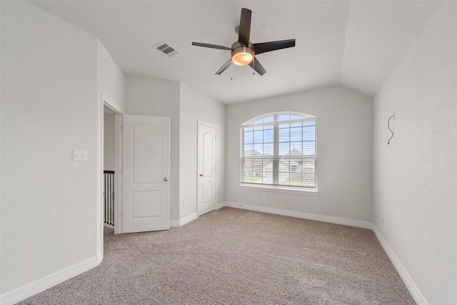 unfurnished bedroom featuring ceiling fan, light colored carpet, and vaulted ceiling