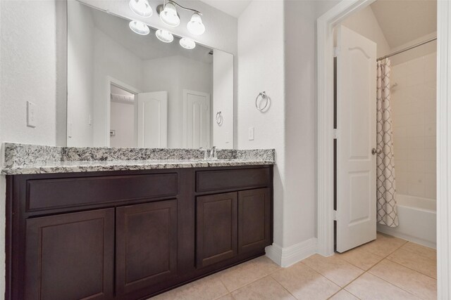 bathroom with tile patterned flooring, shower / bath combo, and vanity