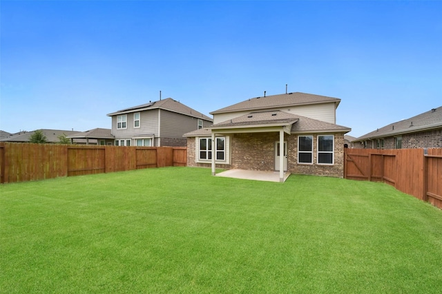 back of property with a yard and a patio