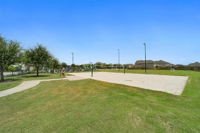 view of property's community with a yard and volleyball court