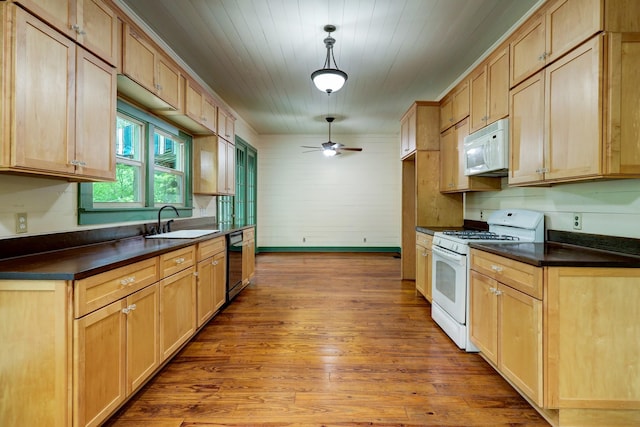 kitchen featuring white appliances, ceiling fan, sink, decorative light fixtures, and hardwood / wood-style floors