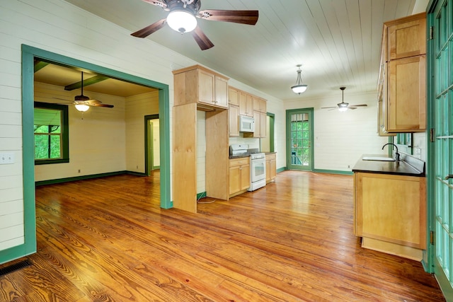 kitchen with light brown cabinets, light hardwood / wood-style flooring, white appliances, and sink