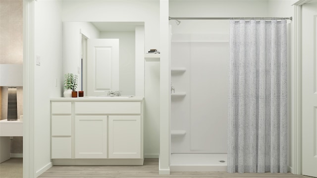 bathroom with a shower with shower curtain, vanity, and hardwood / wood-style flooring