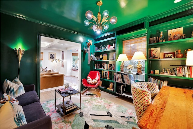 sitting room featuring an inviting chandelier, ornamental molding, and hardwood / wood-style flooring