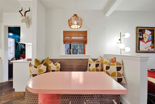 dining area featuring beam ceiling and breakfast area