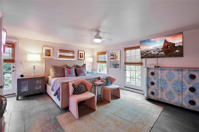 bedroom featuring access to outside, multiple windows, ceiling fan, and dark hardwood / wood-style floors