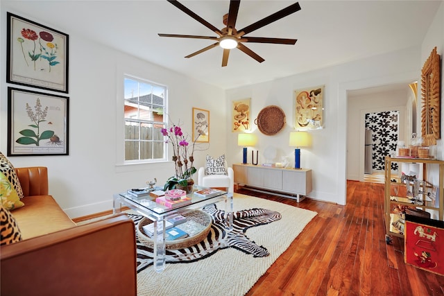 living room featuring ceiling fan and dark hardwood / wood-style flooring