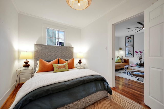 bedroom featuring hardwood / wood-style floors and crown molding