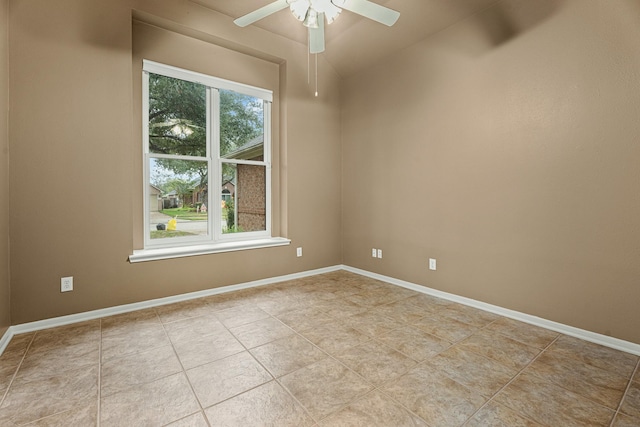 tiled spare room with ceiling fan