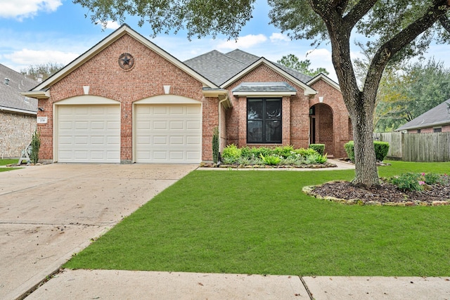 view of front of home featuring a front yard and a garage