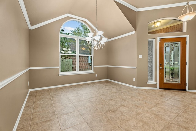 foyer with a notable chandelier, ornamental molding, and vaulted ceiling