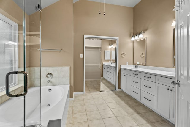 bathroom featuring tile patterned flooring, vanity, and a bathtub