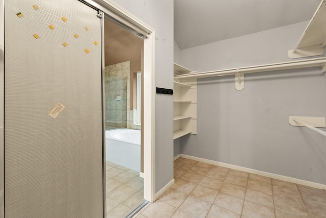 spacious closet with light tile patterned floors