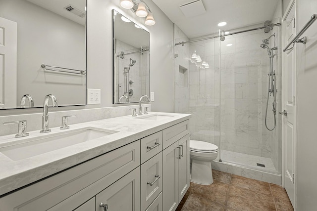 bathroom featuring vanity, toilet, and walk in shower