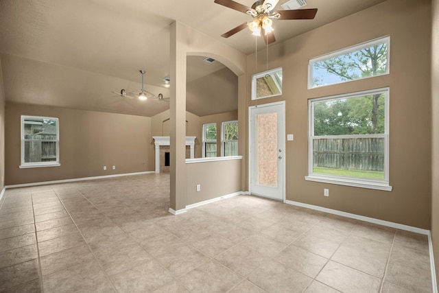 unfurnished living room with ceiling fan, light tile patterned floors, and high vaulted ceiling