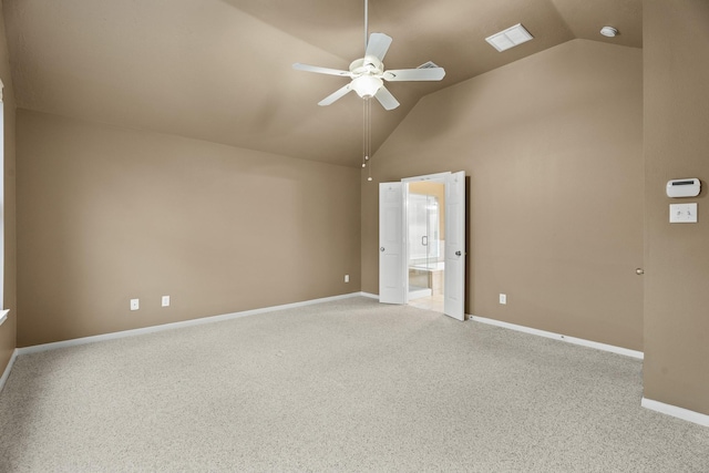 carpeted empty room with ceiling fan and vaulted ceiling