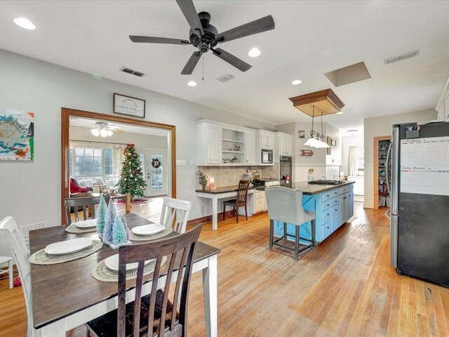 dining space featuring light wood-type flooring