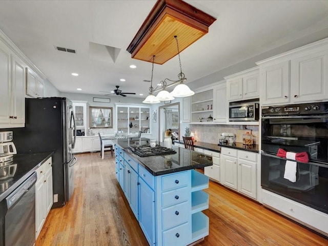 kitchen featuring pendant lighting, a center island, white cabinetry, and stainless steel appliances