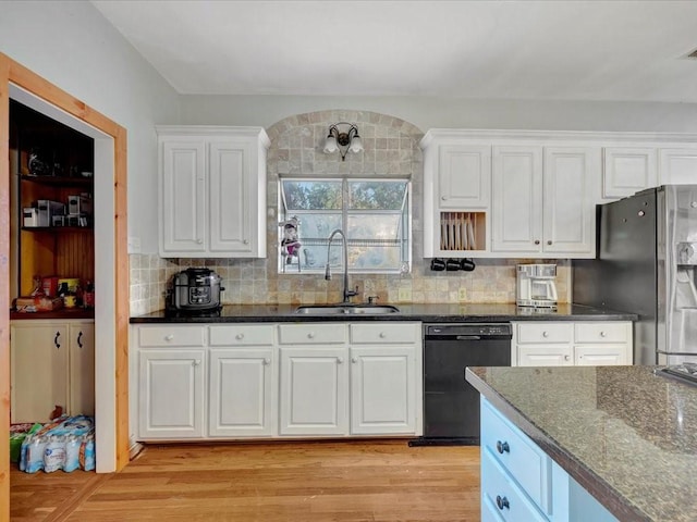 kitchen featuring white cabinets, sink, light wood-type flooring, black dishwasher, and stainless steel fridge with ice dispenser