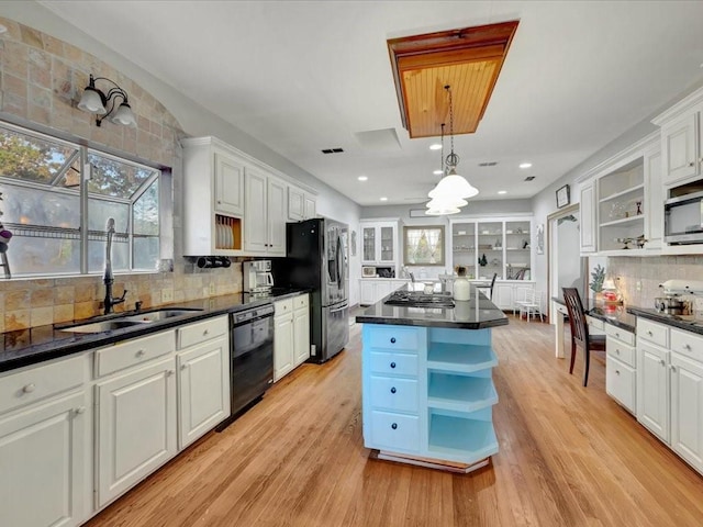 kitchen with white cabinets, stainless steel appliances, and light hardwood / wood-style floors