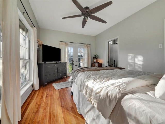 bedroom featuring access to exterior, french doors, light wood-type flooring, and ceiling fan