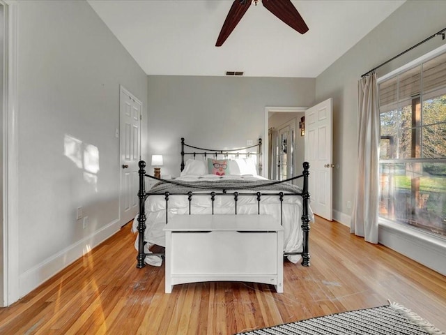 bedroom with light hardwood / wood-style flooring and ceiling fan