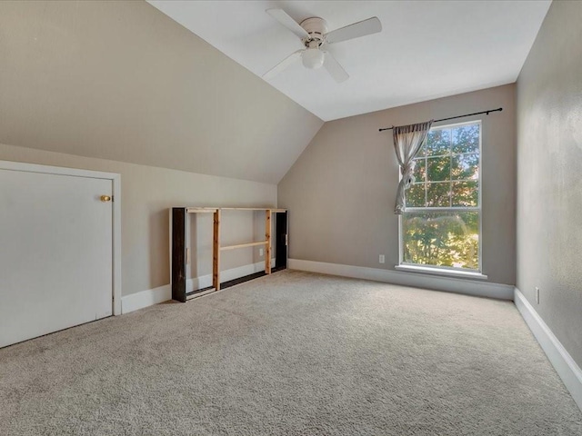 bonus room featuring light colored carpet, ceiling fan, and lofted ceiling