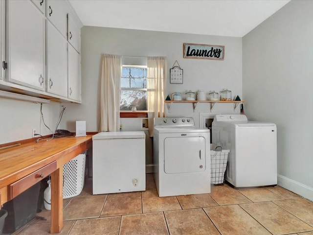 laundry area with cabinets, light tile patterned floors, and washing machine and dryer